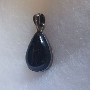 Nuumite Pendant Surrounded By Silver